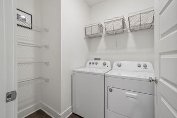 A laundry room with a washer and dryer at Turnberry Park Luxury Rental Homes in Gardendale, AL